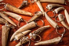 several pieces of wood and metal are on a table with some animal horns hanging from it's sides