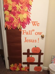 a door decorated with handprinted paper and fall decorations for kids to decorate on