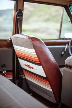 the interior of an old car with a seat cushion and arm rest upholstered