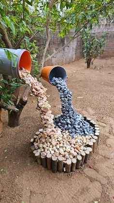 a pile of rocks and gravel pouring out of two buckets into a tree stump