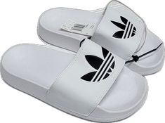 White Synthetic Slip-on Slippers, Trendy White Beach Slippers, Casual White Slip-on Flip Flops, Adidas Non-slip Flat Slides, Casual White Vacation Slippers, White Non-slip Slides For The Beach, White Non-slip Flip Flops For The Beach, Comfortable White Slip-on Sandals, Adidas Non-slip Summer Slides