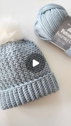 a crocheted hat next to a ball of yarn