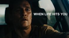 a man in a car with the words when life hits you