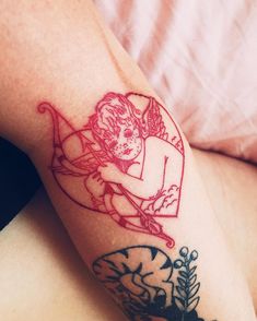 a woman's arm with a tattoo on it that has an image of a man holding a bow and arrow