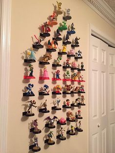 a bunch of toy figurines are hanging on the wall