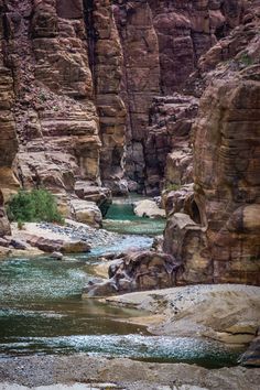 a river flowing through a canyon surrounded by rocks