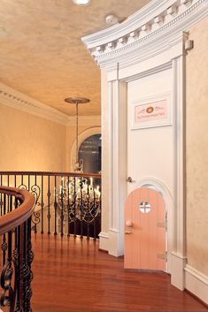 an entry way with a pink door and railing