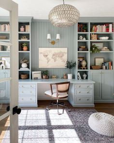 a home office with built in bookcases and a rug