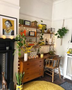 a living room filled with lots of furniture and plants on top of wooden shelves next to a fire place