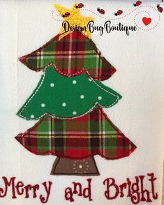 a christmas tree applique on a white towel with merry and bright written across it