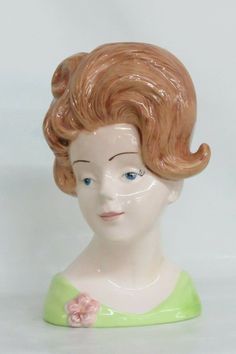 "This gorgeous Lady Head Vase is made of ceramic. This is a wonderful piece of pottery that is a great example of mid century design; this headvase is a beautifully sculpted and painted portrait of a gorgeous young lady with brown hair, wearing a green dress and a pink flower brooch. Please note there is no makers mark or stamp to confirm origin, it is a reproduction of famous mid century headvases. Please see photos of measurements for size/scale, the height of this headvase is approximately 9 Gorgeous Lady, Head Vases, King Size Headboard, Head Vase, Vintage Lucite, Mid Century Style, Green Hair, Gold Paint, Flower Brooch