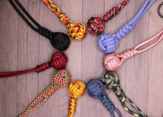 there are many different colored ropes on the table with one knot in the middle and another knot in the middle