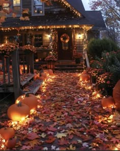 a house decorated for halloween with pumpkins and lights