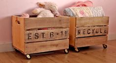 two wooden crates with stuffed animals in them sitting on the floor next to a pink wall