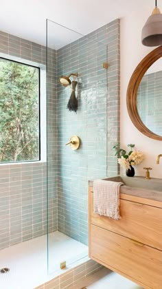 a bathroom with a sink, mirror and shower