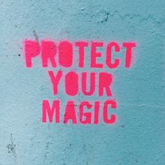 the words protect your magic written in pink spray paint on a blue wall with graffiti