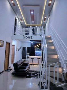 a living room filled with furniture and stairs