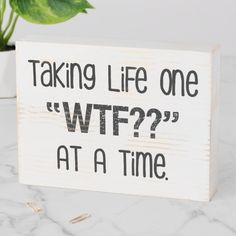 a wooden sign that says taking life one wf? at a time