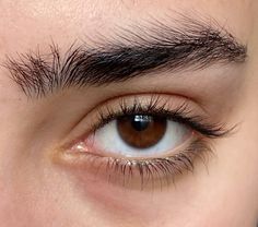 a close up of a person's eye with long eyelashes