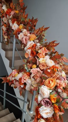 an arrangement of flowers is on the stairs