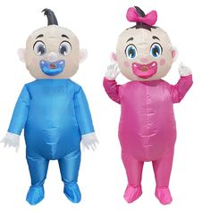 two inflatable babies are standing next to each other, one is wearing a pink and blue outfit