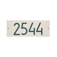 a white and green house number sign with the numbers 25 - 544 on it