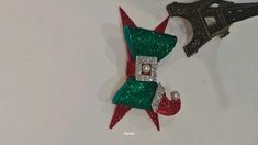 an ornament shaped like the eiffel tower and elf hat with pearls