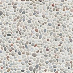 a white and grey stone wall with lots of small stones on it's surface