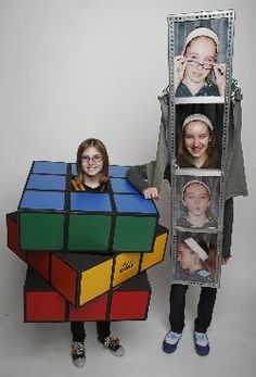 two children are posing with rubik cubes in front of their faces and one child is holding the rubik cube