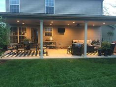 the back porch is lit up with outdoor lighting