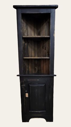 an old black bookcase with wooden shelves and doors on the front, against a white background