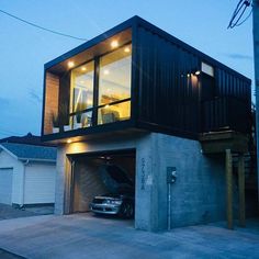 a car is parked in front of a house that has been built into the ground