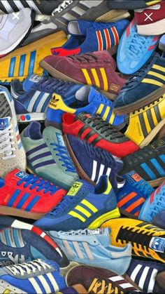 many different colored adidas sneakers are stacked on top of each other in this pile