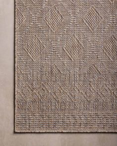 an area rug made out of jute and woven with a diamond pattern on it