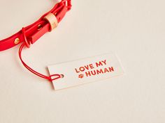 a red cord with a tag that says love my human