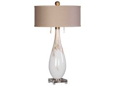 a table lamp with a beige shade on it