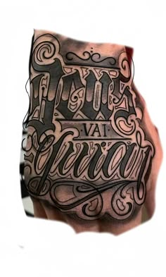 a man's hand with some type of lettering on his left arm and chest