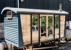 an old outhouse is being built into the ground with wood planks on it