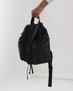 A backpack for all seasons and all phases of life—for school, for work, for life in general. Two exterior zip pockets keep things easily accessible, and an interior sleeve keeps your laptop secure. 13" interior laptop sleeve Expandable drawstring and buckle closure Two exterior and one interior zippered pockets Measures 14 ½" × 14" × 6 30" adjustable logo straps Recycled heavyweight nylon exterior, recycled ripstop nylon interior Machine washable Sport Backpack, Cool Clothing, Backpack Sport, Scarf Men, Mens Skin Care, Reusable Bags, Black Backpack, Men's Grooming, Sock Shoes