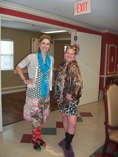 two women standing next to each other in a room