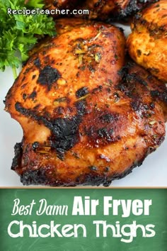 the best damn air fryer chicken thighs recipe on a white plate with parsley