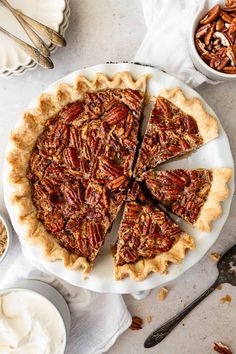 a pecan pie is cut into slices on a plate