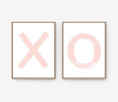 two pink and white paintings with the letter x on them