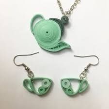 three pieces of jewelry made to look like teapots