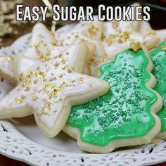 cookies decorated with green and white icing on a plate that says easy sugar cookies