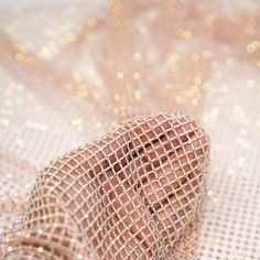 a piece of pink fabric with gold sequins on it