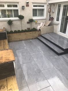 an outdoor patio with steps leading up to the front door