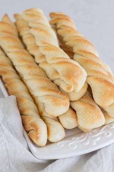 some bread sticks are on a white plate