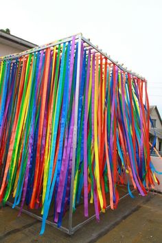 colorful streamers are hanging from the side of a building