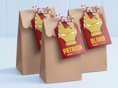 three brown paper bags with iron man tags on them